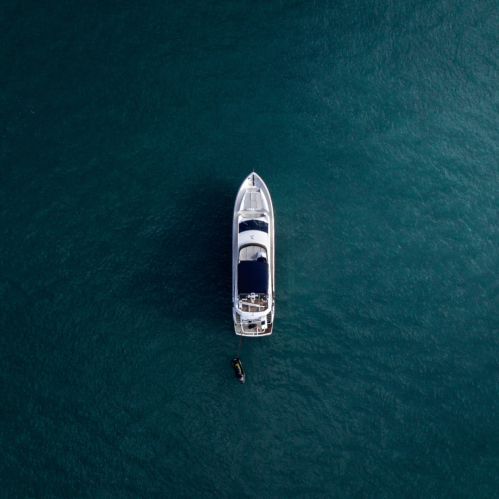 Aerial view of lone yacht in expanse of ocean