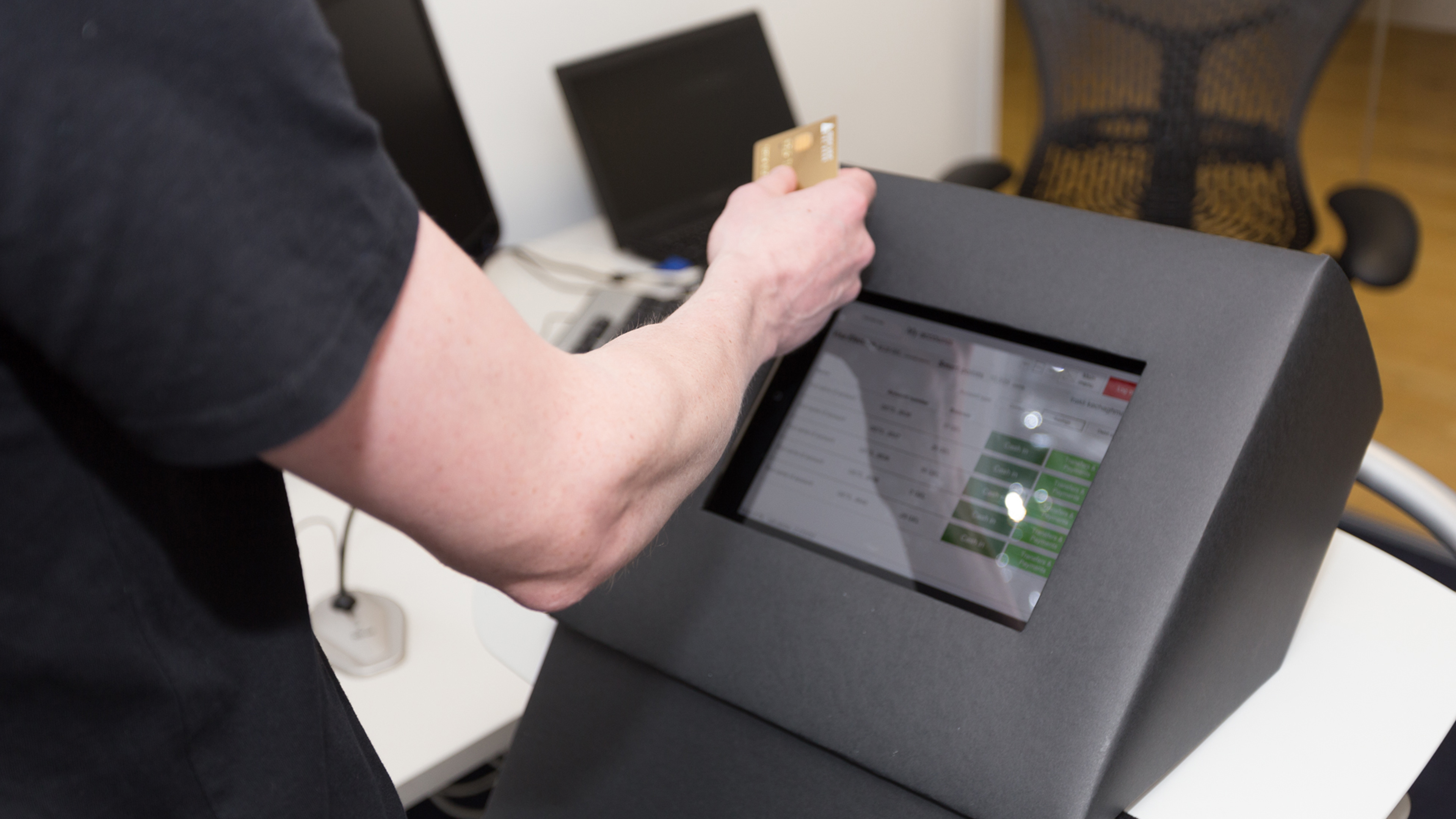 a man hand holding a credit card against a machine