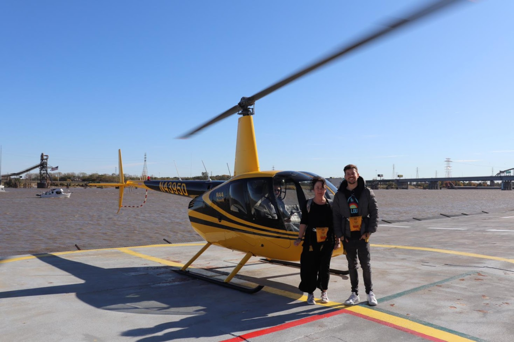 Andrew and Allie standing outside a helicopter