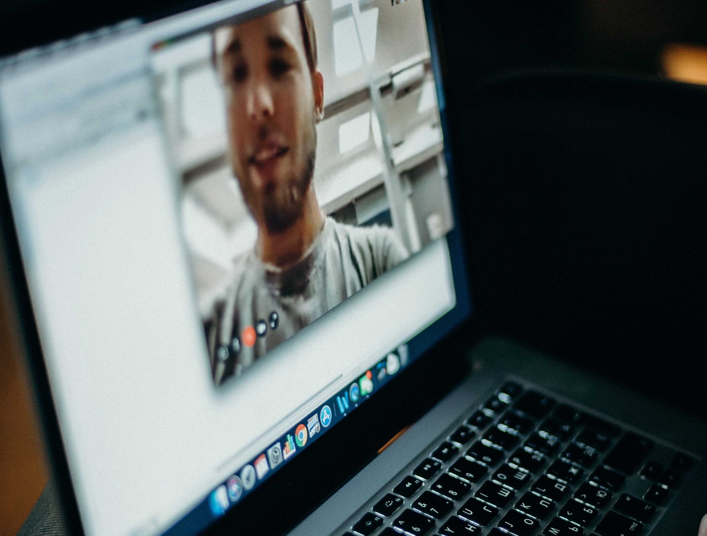 Laptop showing man on video call