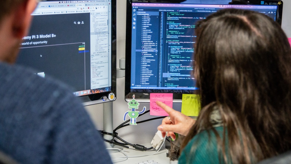 Box UK developers discussing code on screens