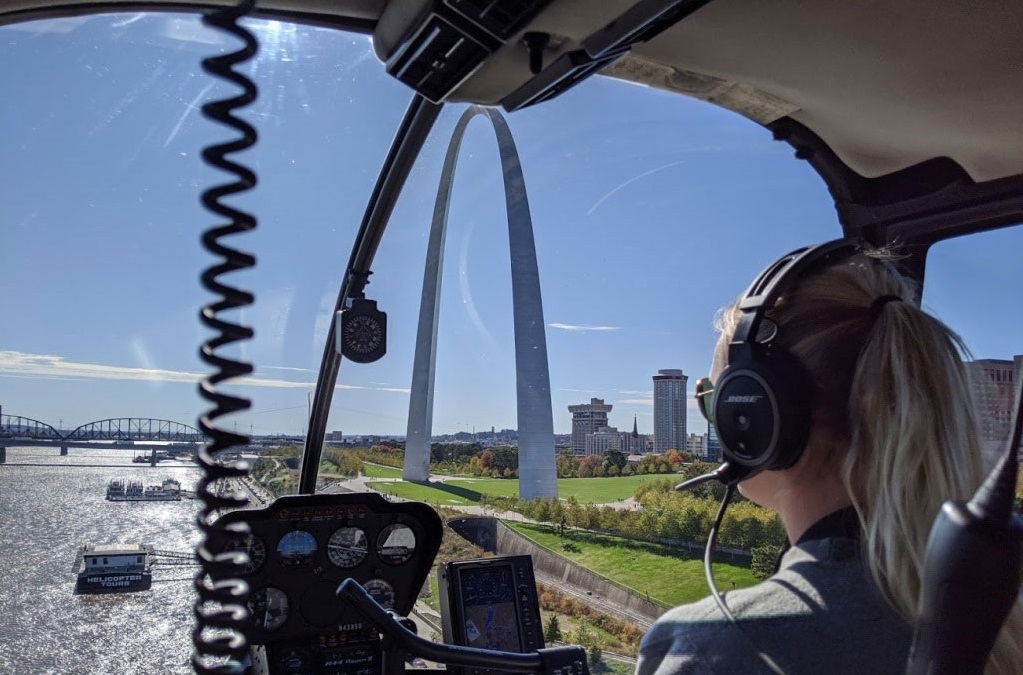 View of inside of helicopter with Gateway Arch beyond