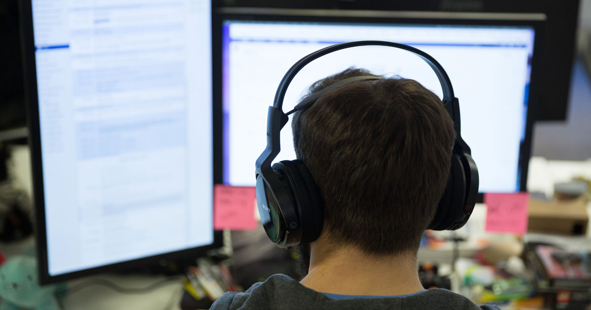 Developer working at two screens