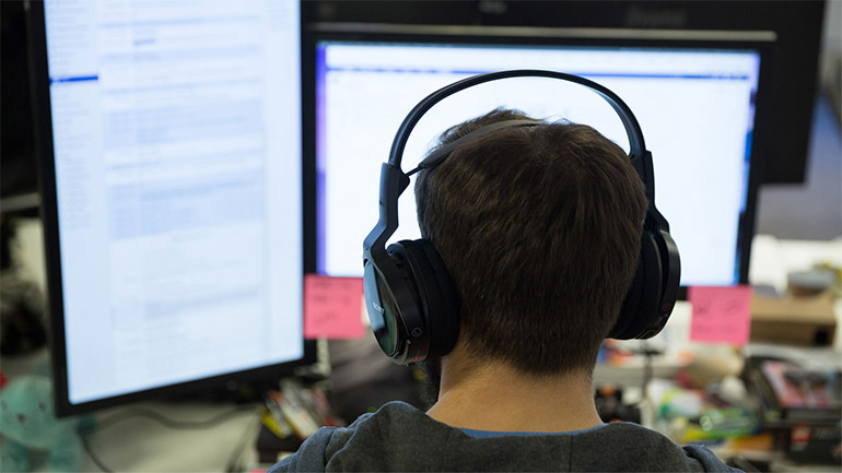 Developer working at two screens