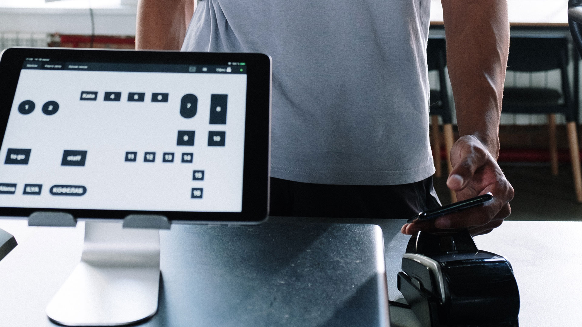 Person making contactless payment using smartphone