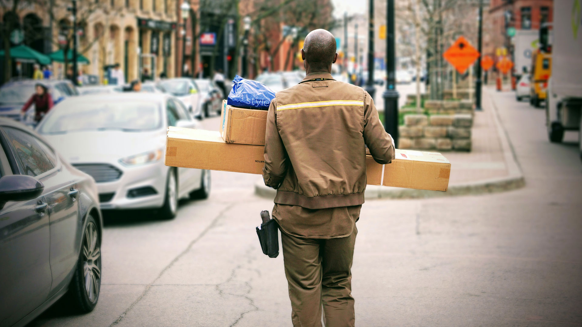 Back of a delivery man with parcels