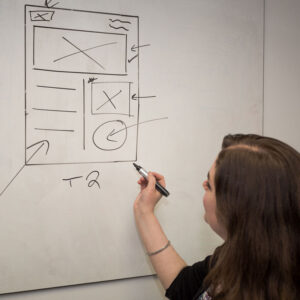 Person sketching out ideas for a web page