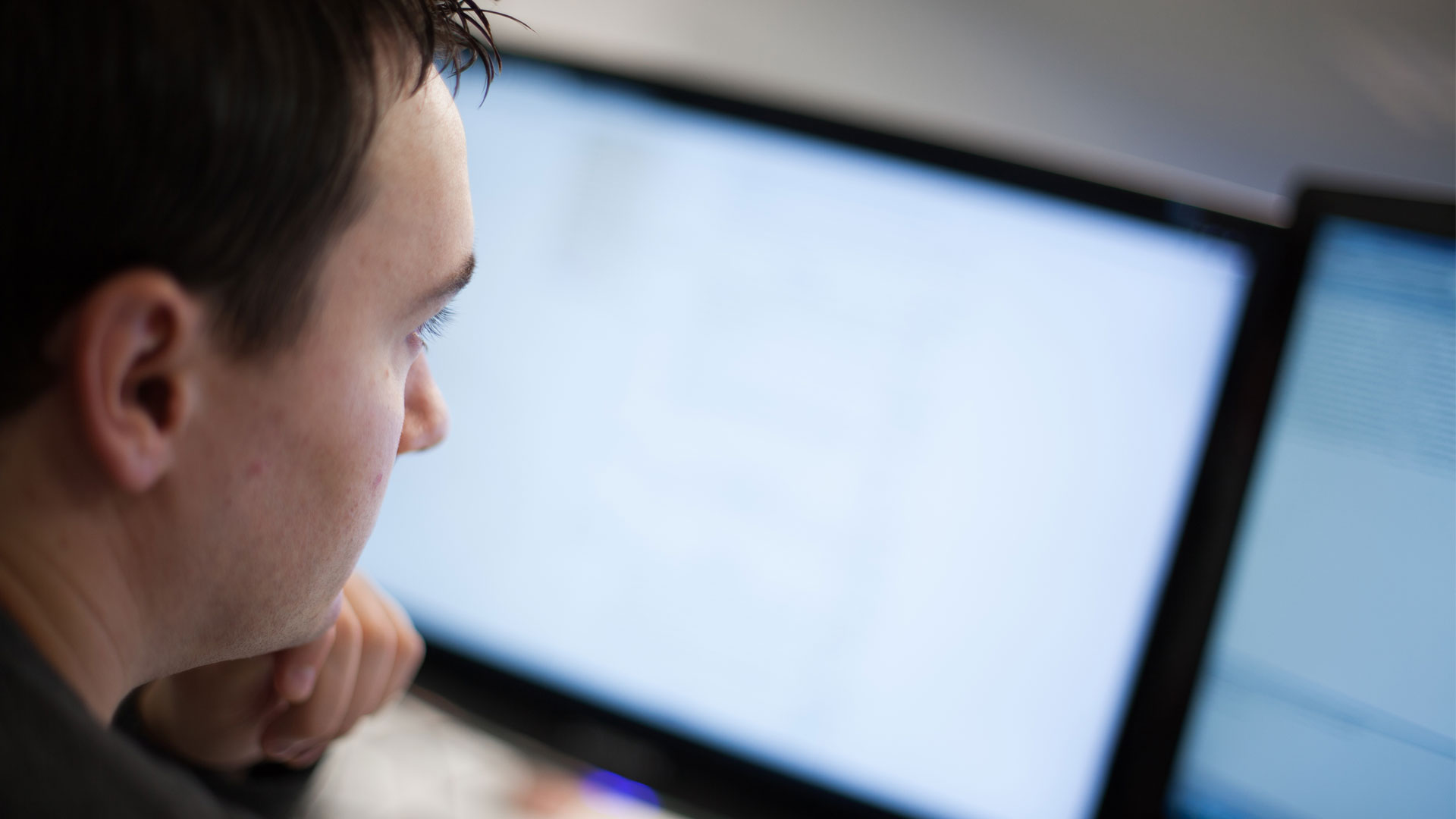 Person looking at two computer screens