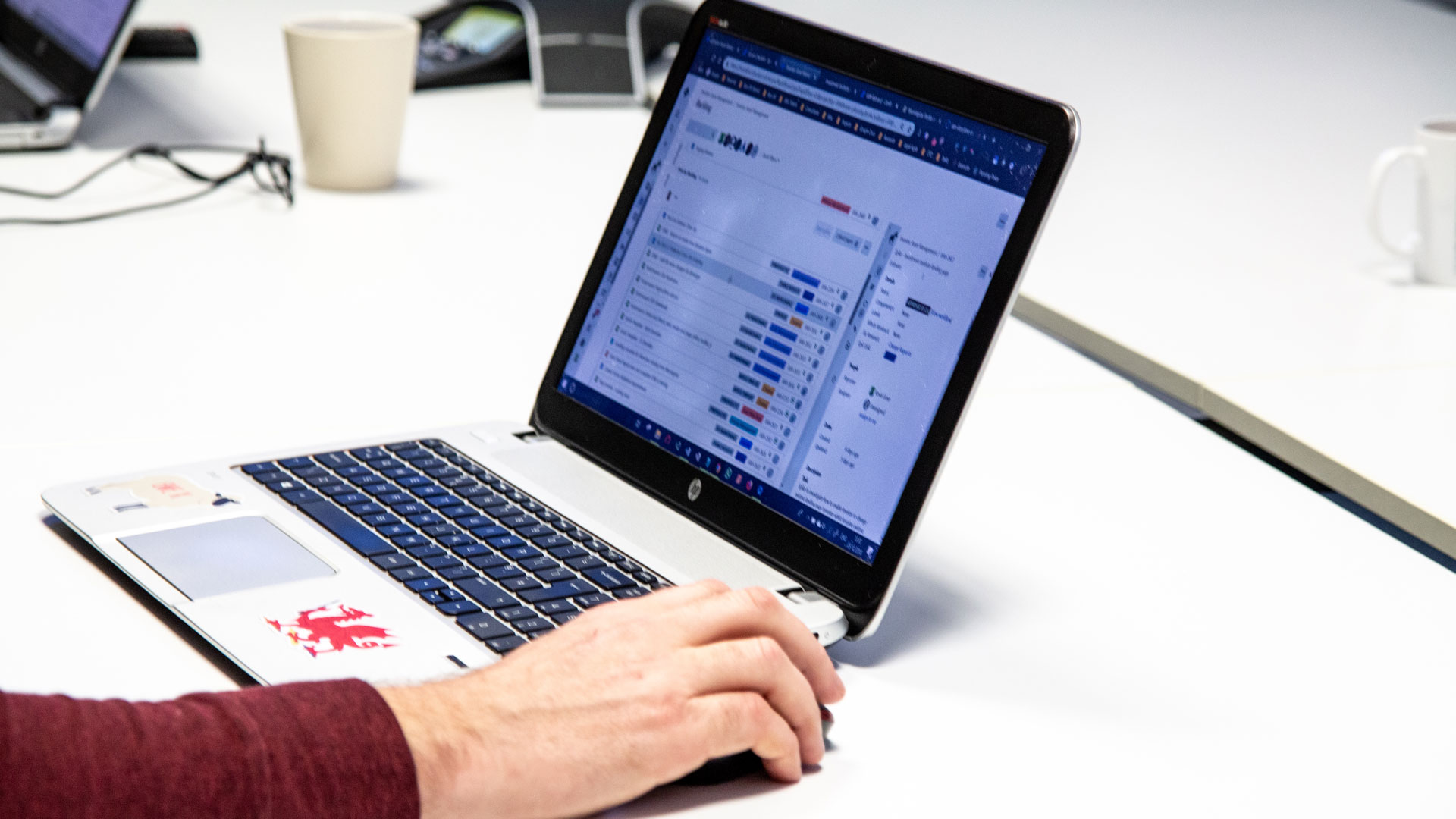 Close-up of laptop and person's hand