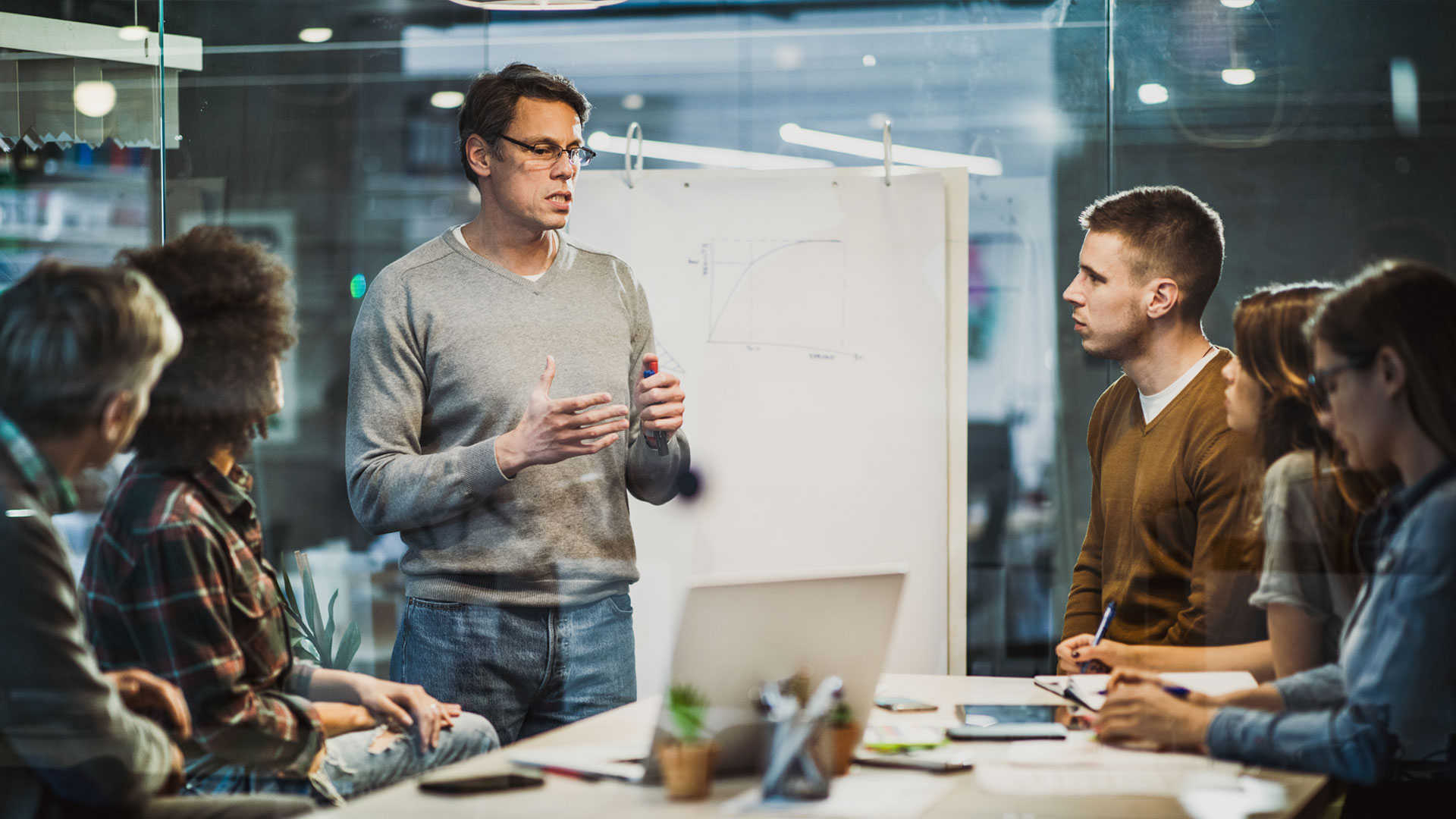 Group of people in front of an ideas pad having a discussion