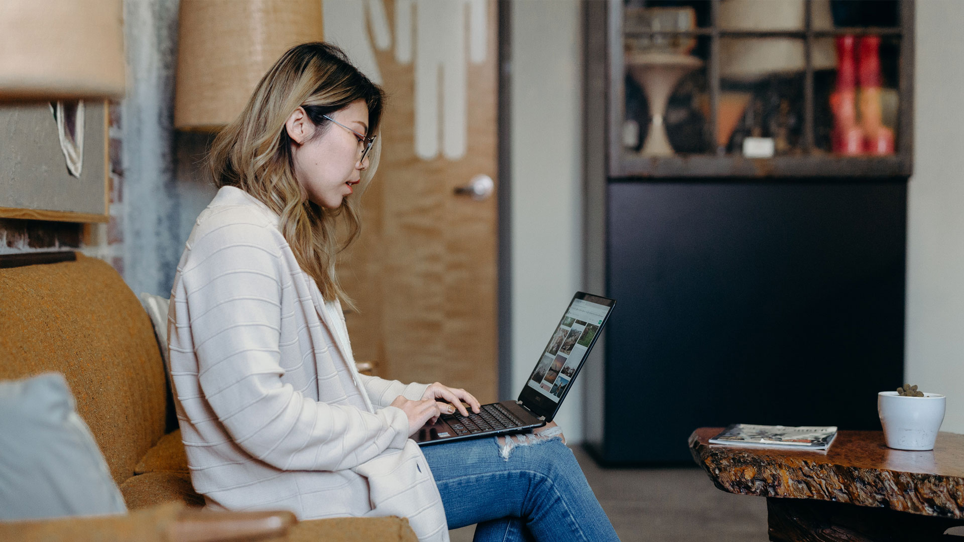 Person sat on sofa using laptop