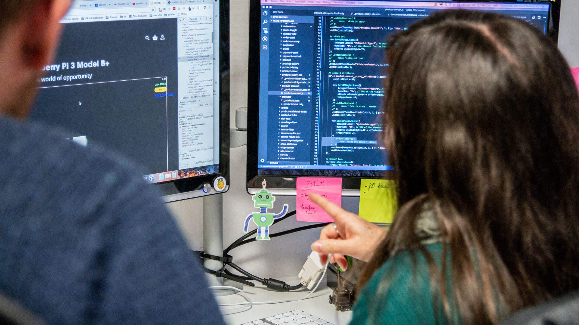 Two developers working on a double screen